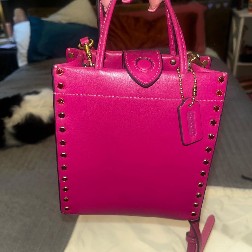 pink magenta Coach crossbody bag with crystals along the sides
